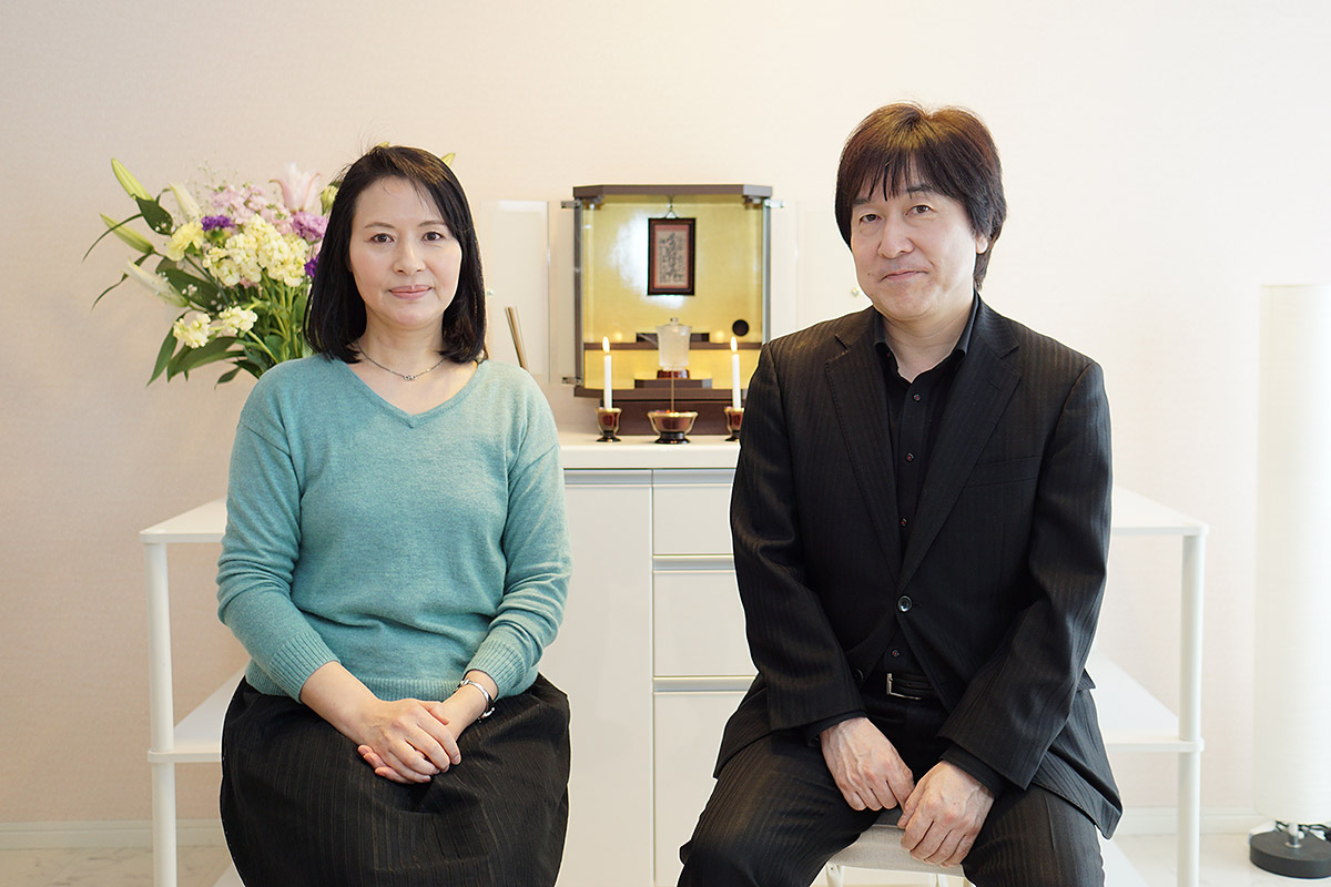 Seiko Oda (left) and Kōji Morita (right) in front of the Buddhist altar in their office